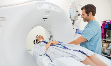 radiology tech helping a patient with a scan